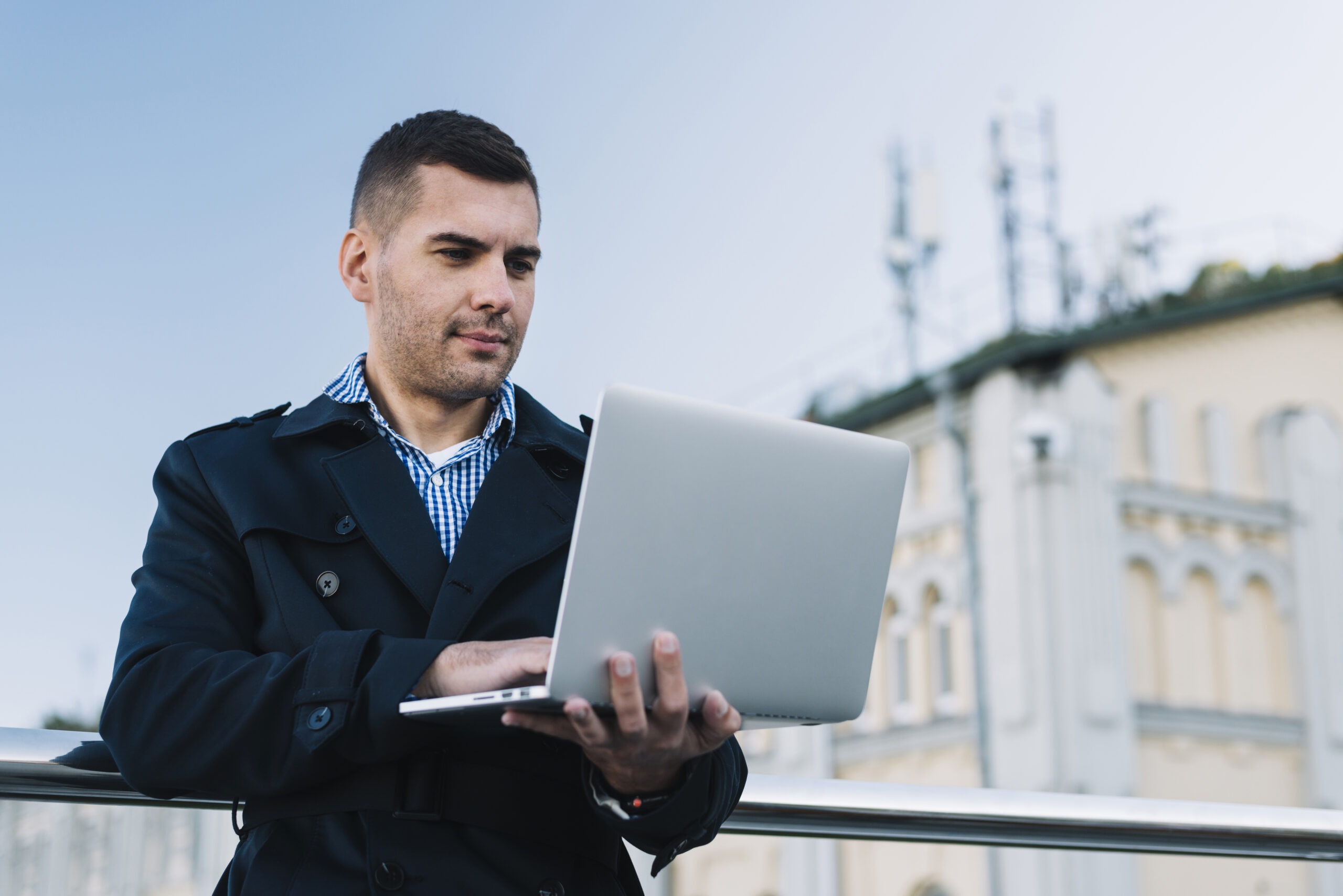 man-using-laptop-urban-environment